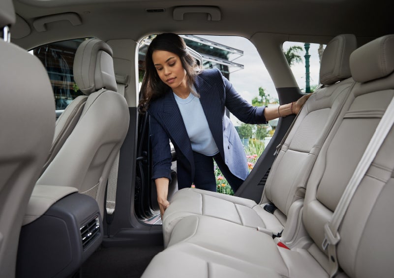 A woman slides the second-row seat forward to create more cargo space | Pierre Lincoln in Lynnwood WA