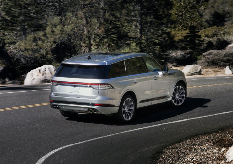 A 2023 Lincoln Aviator® Grand Touring model is shown being driven on a tight turn of a mountain road | Pierre Lincoln in Lynnwood WA