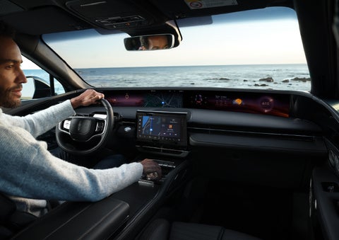 A driver of a parked 2024 Lincoln Nautilus® SUV takes a relaxing moment at a seaside overlook while inside his Nautilus. | Pierre Lincoln in Lynnwood WA