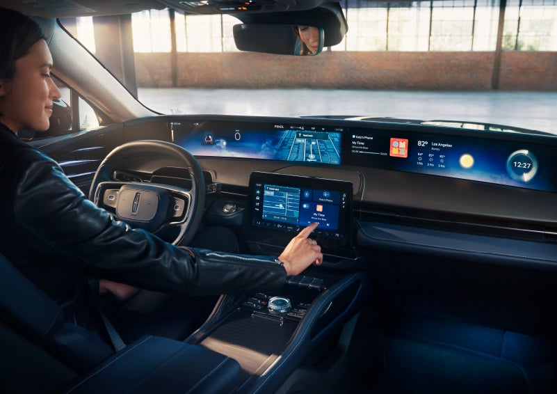 The driver of a 2024 Lincoln Nautilus® SUV interacts with the center touchscreen. | Pierre Lincoln in Lynnwood WA