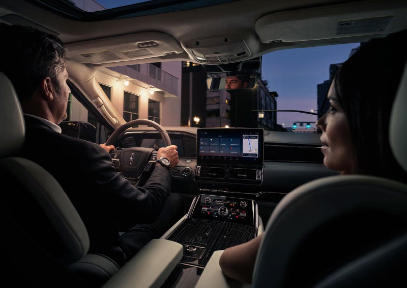 A couple is relaxing inside their quiet and serene 2024 Lincoln Navigator® SUV